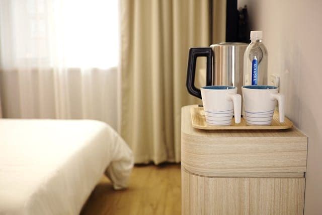 Enjoy complimentary tea and coffee from the comfort of your bedside in our bright, minimalist room.