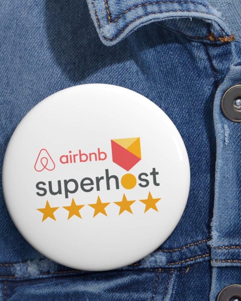 An Airbnb Superhost Pin Button gleams with five stars on a denim jacket, representing the highest standard in Airbnb Hosting excellence.