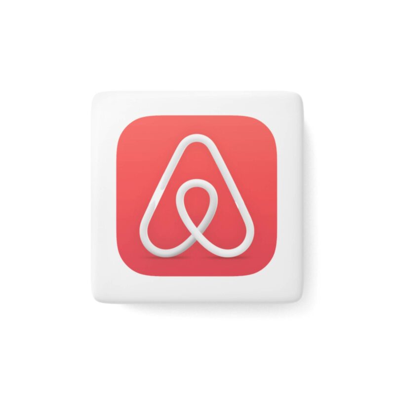 The Airbnb Porcelain Magnet, Square sports a white abstract design within a rounded red square background featuring the Airbnb logo.