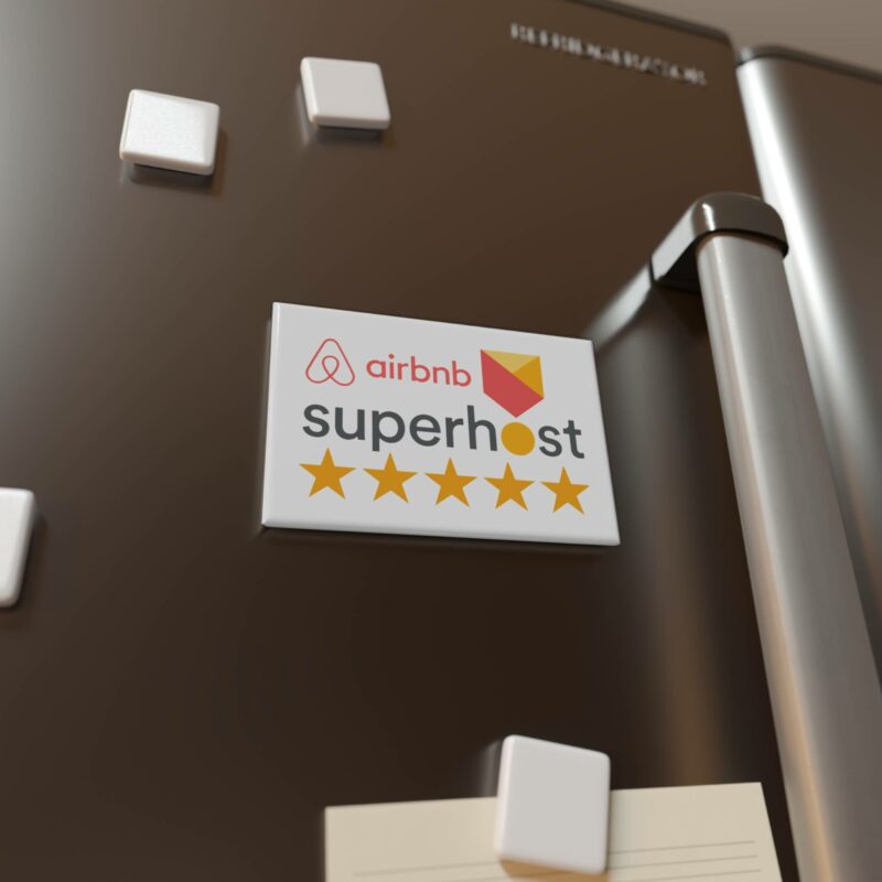 A refrigerator with an "I'm an Airbnb Superhost" button magnet, rectangle (1 & 10 pcs), displaying five stars is shown in close-up.