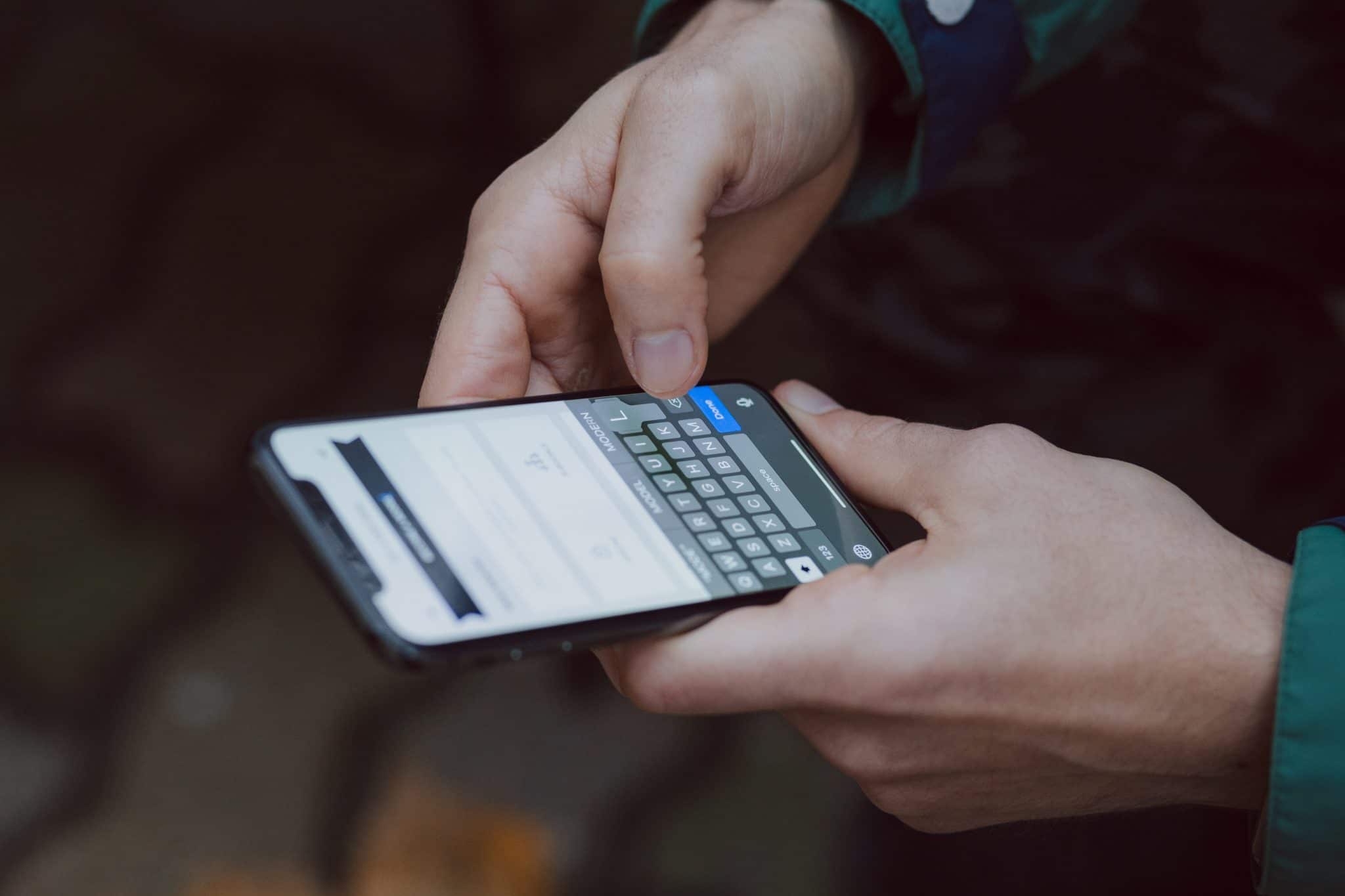 Airbnb Hosting A person's hand holding a smartphone while Airbnb hosting.