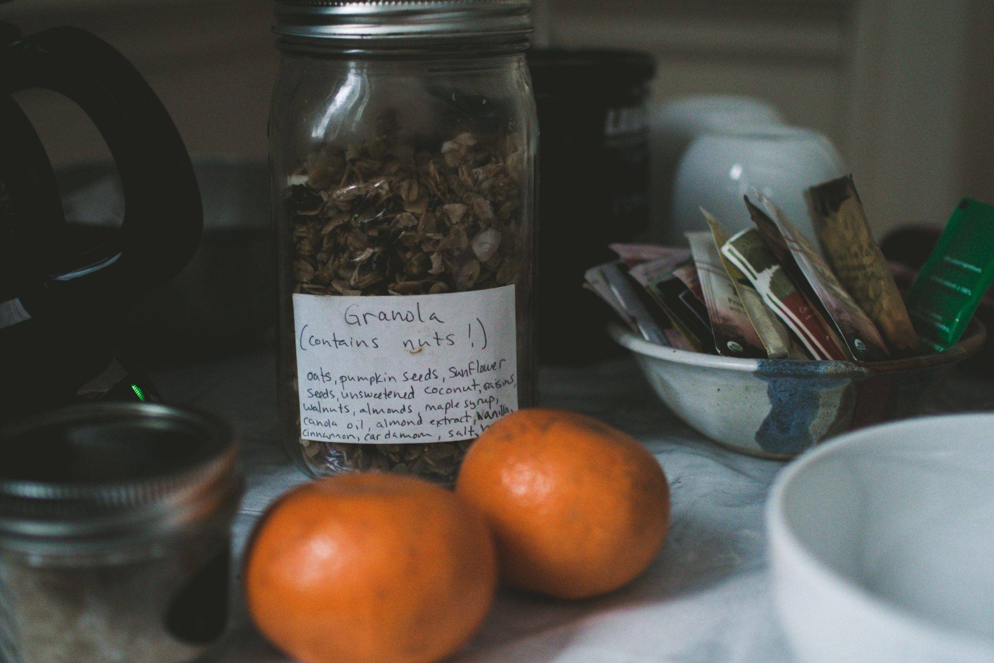 Airbnb Hosting An Airbnb hosting setup includes a jar of granola and oranges on the table.