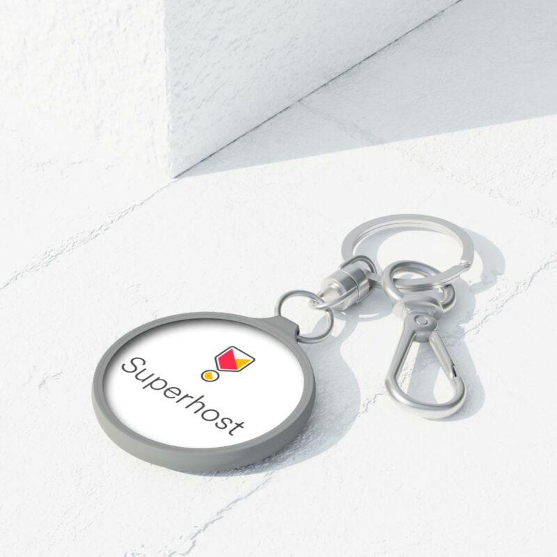 The "I'm an Airbnb Superhost Keyring Tag" is a metal keychain featuring a red and yellow badge emblem with the word "Superhost" inscribed, displayed on a white surface. It's perfect for showcasing your dedication to exceptional Airbnb hosting.