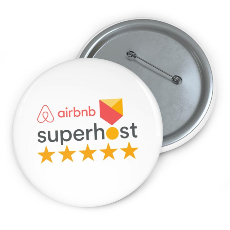 The Airbnb Superhost Pin Buttons showcase a white button adorned with the Airbnb logo and the word "superhost," complemented by five gold stars beneath, symbolizing expert hosting tips for an exceptional Airbnb experience.