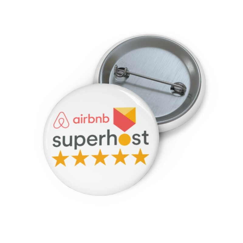 The Airbnb Superhost Pin Buttons, featuring a round design with the Superhost logo and five stars, are elegantly displayed alongside an open pin-back, ideal for those interested in learning Airbnb hosting tips.