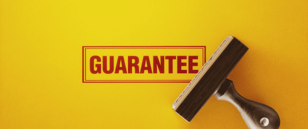 Airbnb Hosting An Airbnb host insurance wooden tool with the word guarantee on it on a yellow background.