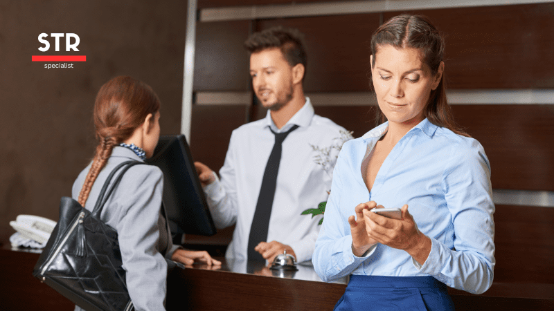 Airbnb Hosting A group of people standing in front of a reception desk, learning how to identify problem guests before they book.