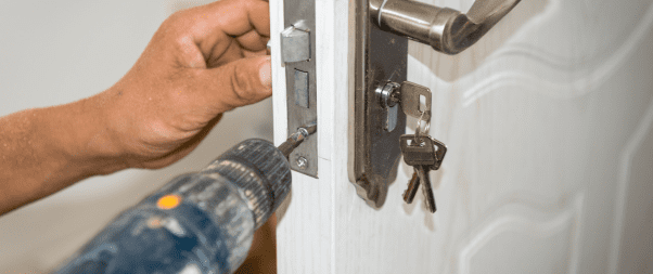 Airbnb Hosting A man using a drill to elevate his Airbnb hosting game by opening a door.