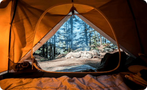Airbnb Hosting The inside of an Airbnb tent with a view of a forest.