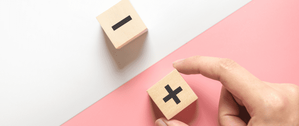 Airbnb Hosting A hand is holding a wooden block with a number on it. NoiseAware and Party Squasher offer smart solutions for monitoring your Airbnb.