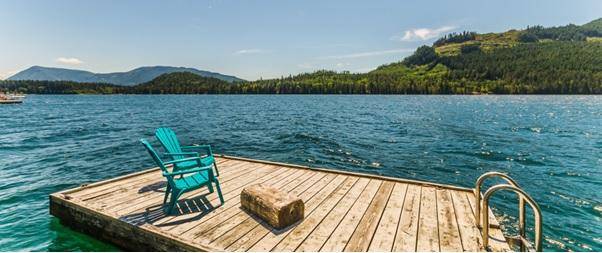 Airbnb Hosting A blue chair sits on a dock in the middle of a lake, providing an ideal spot for an Airbnb retreat.